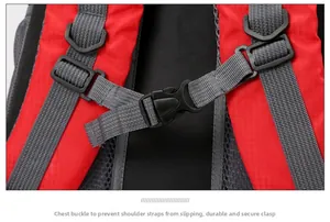 Detail of the durable chest buckle and breathable mesh straps on a red travel backpack