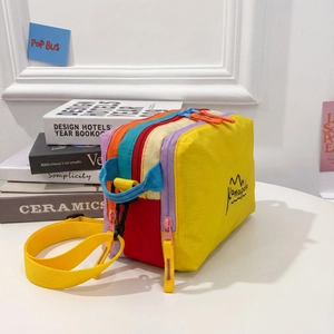 Waterproof multi-compartment crossbody bag in vibrant color block design for travel