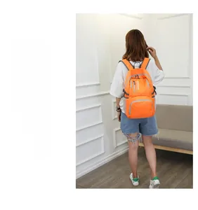 Outdoor foldable orange backpack with multiple zippered pockets and side mesh water bottle holder