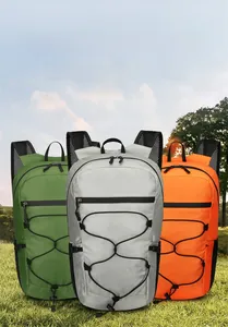 Three colors of lightweight foldable hiking backpacks displayed in outdoor nature scene