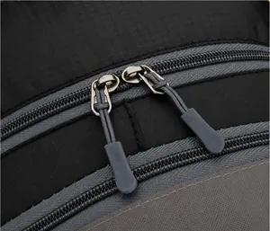 Close-up of durable two-way zipper system and ripstop fabric on outdoor backpack