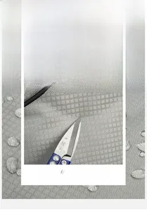 Close-up of waterproof grey plaid nylon fabric showing scratch-resistant material texture
