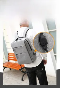 Detail of grey laptop backpack with external USB charging port and durable fabric texture