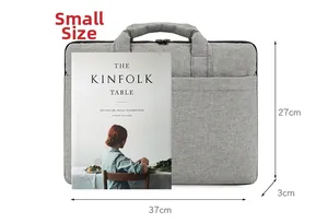 Sacoche ordinateur grise imperméable avec poignée et poche frontale avec un livre