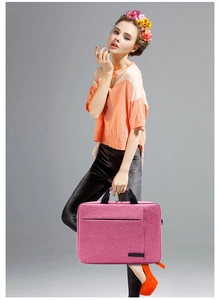 Detail view of pink business laptop briefcase with woven texture and front zipper pocket
