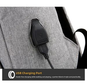 Detail of gray textured backpack showing the integrated USB charging port and cable