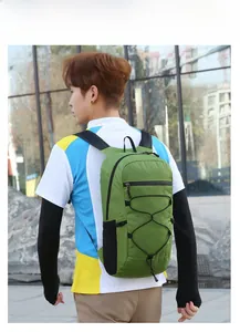 Outdoor foldable backpack in grass green featuring elastic cord system for hiking