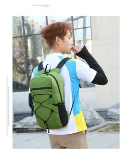 Detail of green sports backpack with black elastic cords and ergonomic mesh shoulder straps