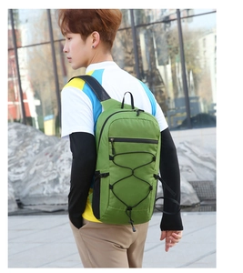 Detail view of lightweight green folding hiking backpack with black adjustable straps