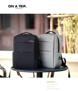 Detail of waterproof business backpack showing USB charging port and zipper pockets