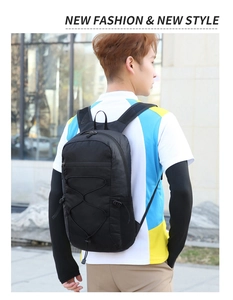 Detail of black outdoor backpack with front bungee cord system and water-resistant fabric