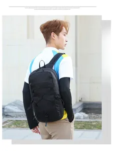 Detail view of black outdoor backpack with elastic bungee cord and durable nylon texture