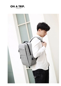 Detail of grey laptop backpack with side USB charging port and reinforced handle
