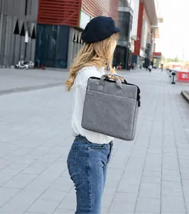 Sacoche pour ordinateur portable en tissu gris avec poignées noires en sangle, vue extérieure
