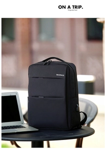 Detail of laptop backpack with USB port and notebook on outdoor table