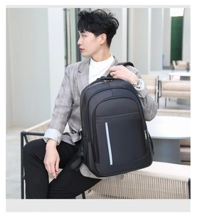 Detail view of black waterproof business backpack featuring vertical reflective safety strip