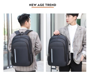 Detail of black business laptop backpack with vertical white reflective strip and handle