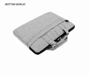 Détail du bas de la sacoche ordinateur grise montrant le tissu durable et le zip