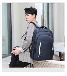 Detail of dark blue business laptop backpack with white stripe in outdoor city setting