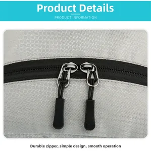 Detail of durable dual zippers with non-slip pull cords on gray folding backpack