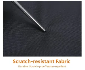 Close-up of scratch-resistant fabric being tested for durability on a black laptop backpack
