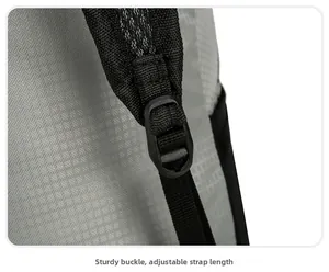 Macro detail of a durable buckle for length adjustment on a gray hiking backpack strap
