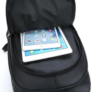 Minimalist black laptop backpack for men showing spacious interior with tablet compartments