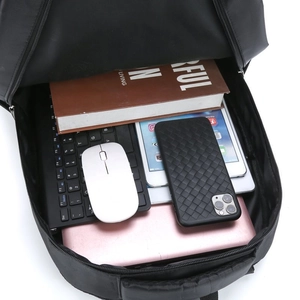 Black business backpack with large capacity showing laptop, keyboard and books inside