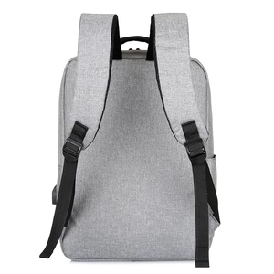 Grey business laptop backpack with USB charging port and thick padded shoulder straps