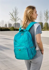 Detail of teal foldable backpack showing large capacity and lightweight nylon fabric