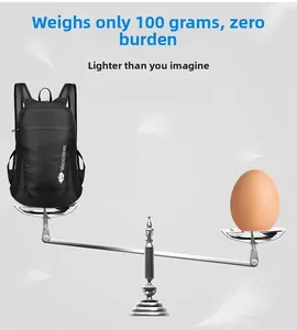 Lightweight black foldable backpack weighing 100g balanced with feathers on scale
