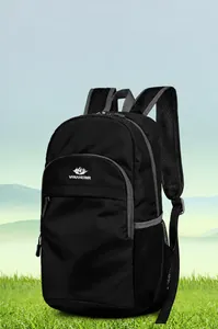 Detail showing the padded mesh shoulder strap of a lightweight black outdoor travel backpack