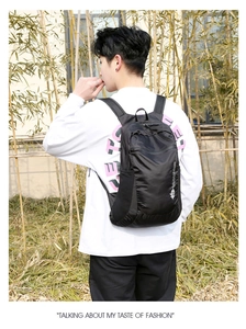 Detail of black waterproof outdoor backpack featuring side zipper and brand logo