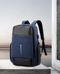 Detail view of business laptop backpack showing integrated USB charging port and navy texture