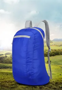 Macro detail of blue lightweight folding backpack featuring grey straps and front zipper