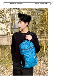 Close-up of blue lightweight foldable backpack with ripstop nylon texture and white logo