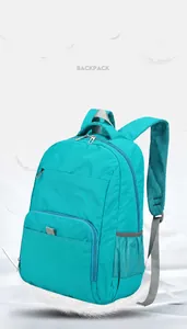 Detail of lightweight blue nylon backpack with mesh side pockets and feather accents