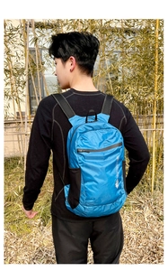 Close-up of lightweight blue ripstop nylon outdoor backpack with side mesh pockets