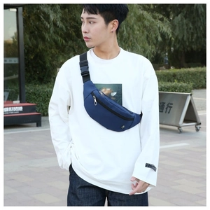 Photo lifestyle d'un sac bandoulière bleu foncé durable avec fermetures éclair argentées