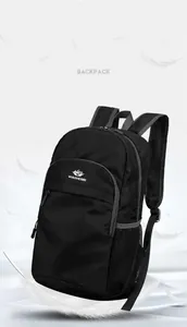 Close-up of lightweight black nylon backpack with mesh side pocket and logo detail
