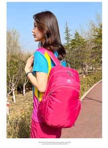 Outdoor lifestyle view of a lightweight rose red foldable waterproof sports backpack