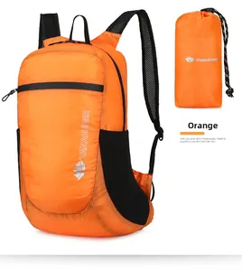 Detail of orange foldable travel backpack with side mesh pocket and compact storage pouch