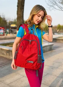 Foldable red outdoor backpack made of waterproof nylon with gray straps and side mesh pocket