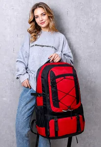 Outdoor backpack with red-black nylon fabric and elastic cords on grey background