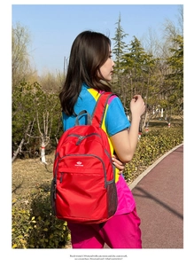 Detail of red water-resistant nylon outdoor backpack with honeycomb texture and mesh side pocket