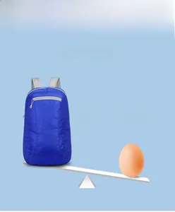 Foldable outdoor backpack weighing only 70g shown on a scale compared to an egg