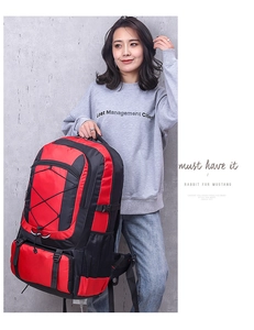 Detail of red and black outdoor hiking backpack with bungee cords and mesh pockets