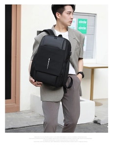 Close-up of black business backpack showing side USB charging port for mobile devices