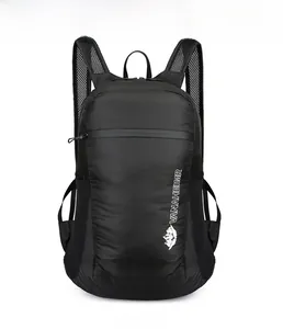 Front detail of black lightweight folding backpack featuring mountain logo and mesh straps