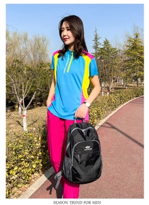 Outdoor lifestyle shot of a black waterproof backpack with multiple zipper pockets